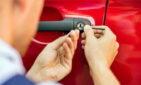 Locksmith opening a car door lock without damage