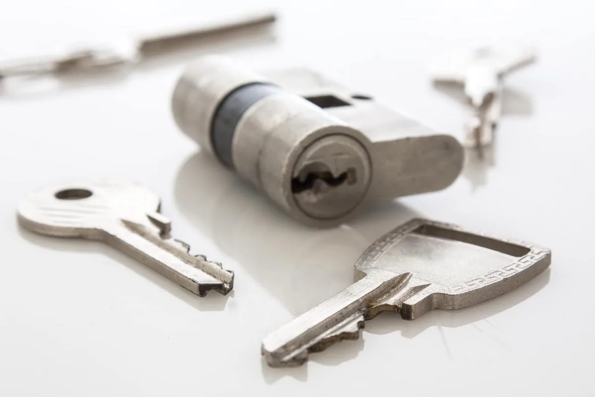Euro cylinder lock and freshly cut keys on the van workbench